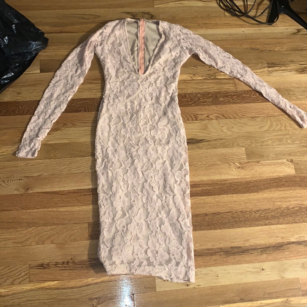 Floral, peach-colored, bodycon dress with V-cut.